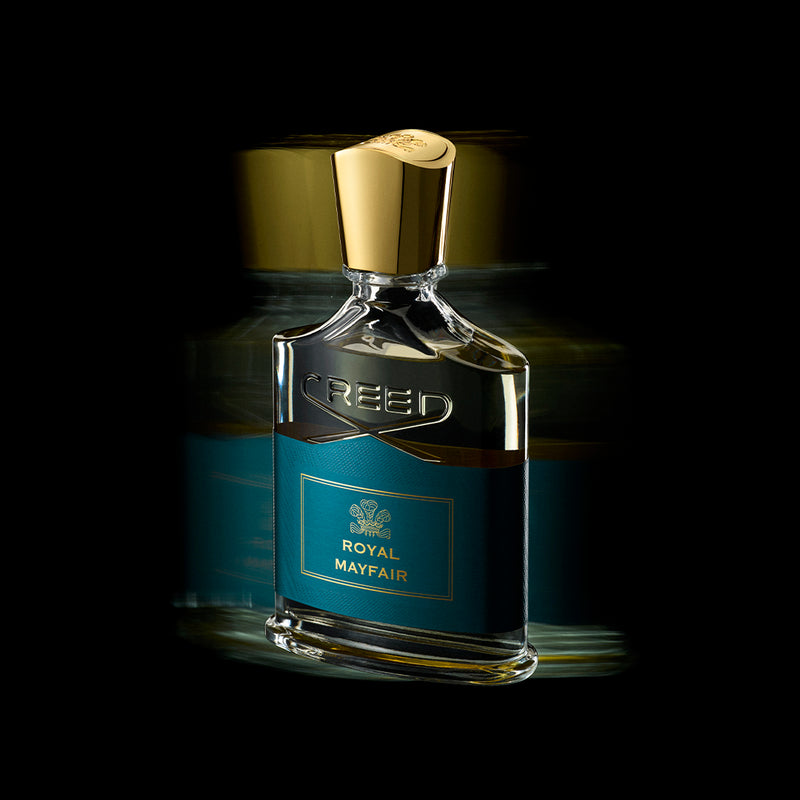 Royal Mayfair blue bottle with gold lid on a black background