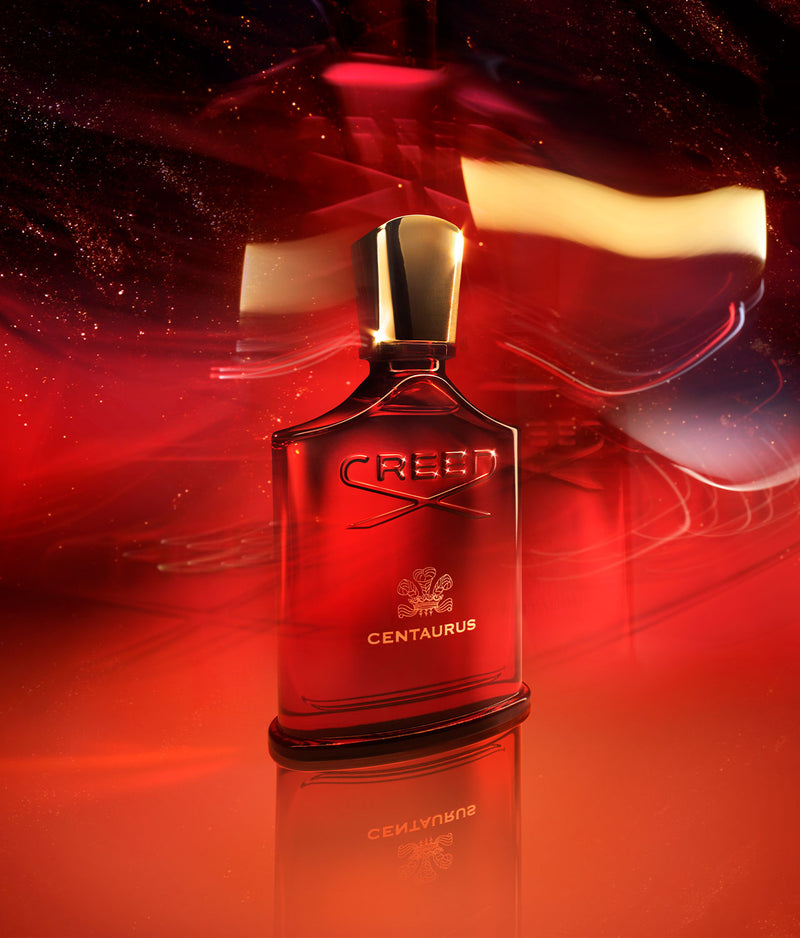 Red Centaurus bottle with red background and gold speckles mimicking a galaxy with stars
