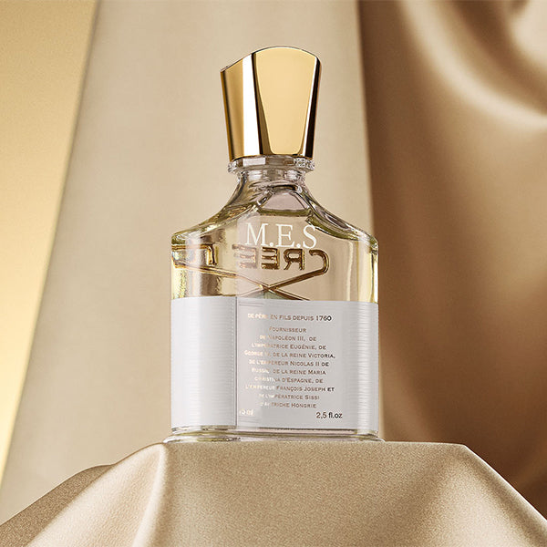 Aventus for her on a gold silk plinth with engravng on the back of the bottle with initials MES